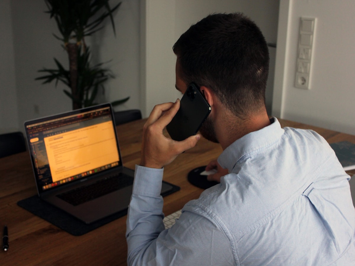On a phone call at the laptop